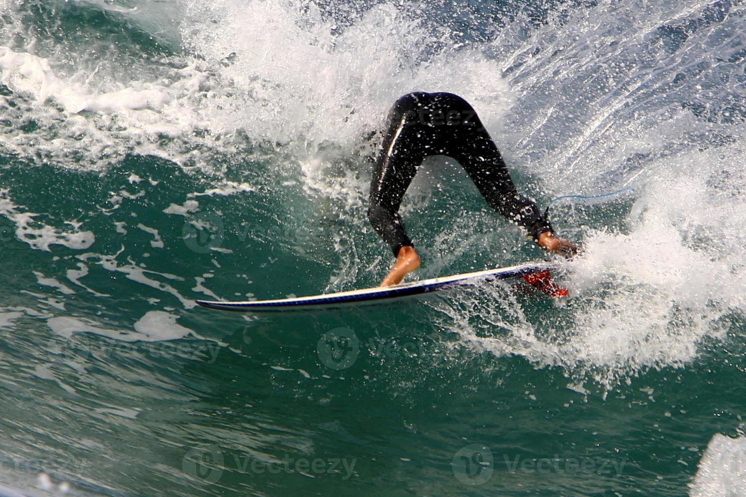 Surfing on high waves on the Mediterranean Sea in northern Israel. photo