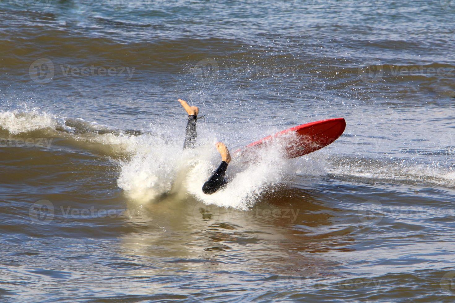 Surfing on high waves on the Mediterranean Sea in northern Israel. photo