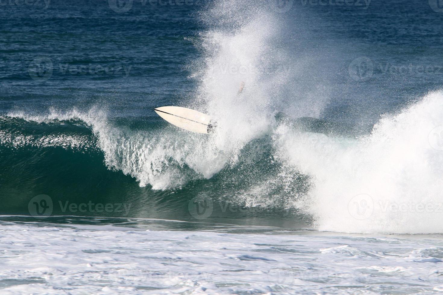 surfeando en olas altas en el mar mediterráneo en el norte de israel. foto