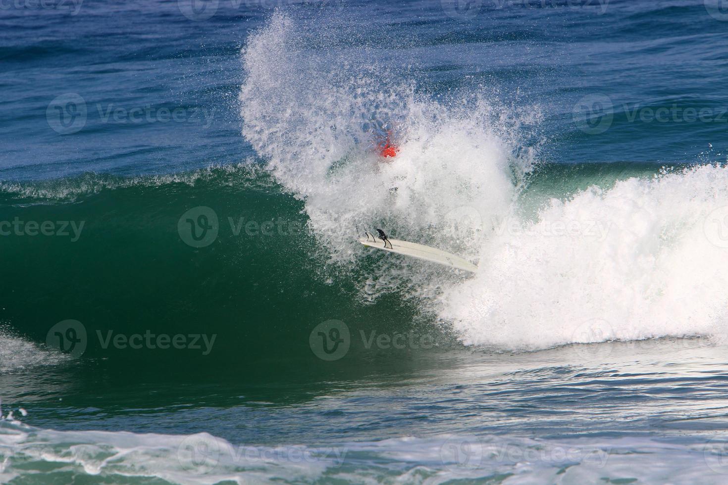 Surfing on high waves on the Mediterranean Sea in northern Israel. photo