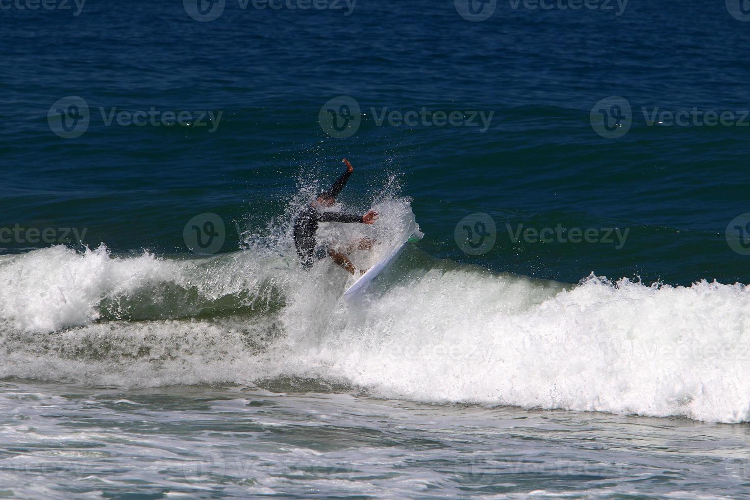 Surfing on high waves on the Mediterranean Sea in northern Israel. photo