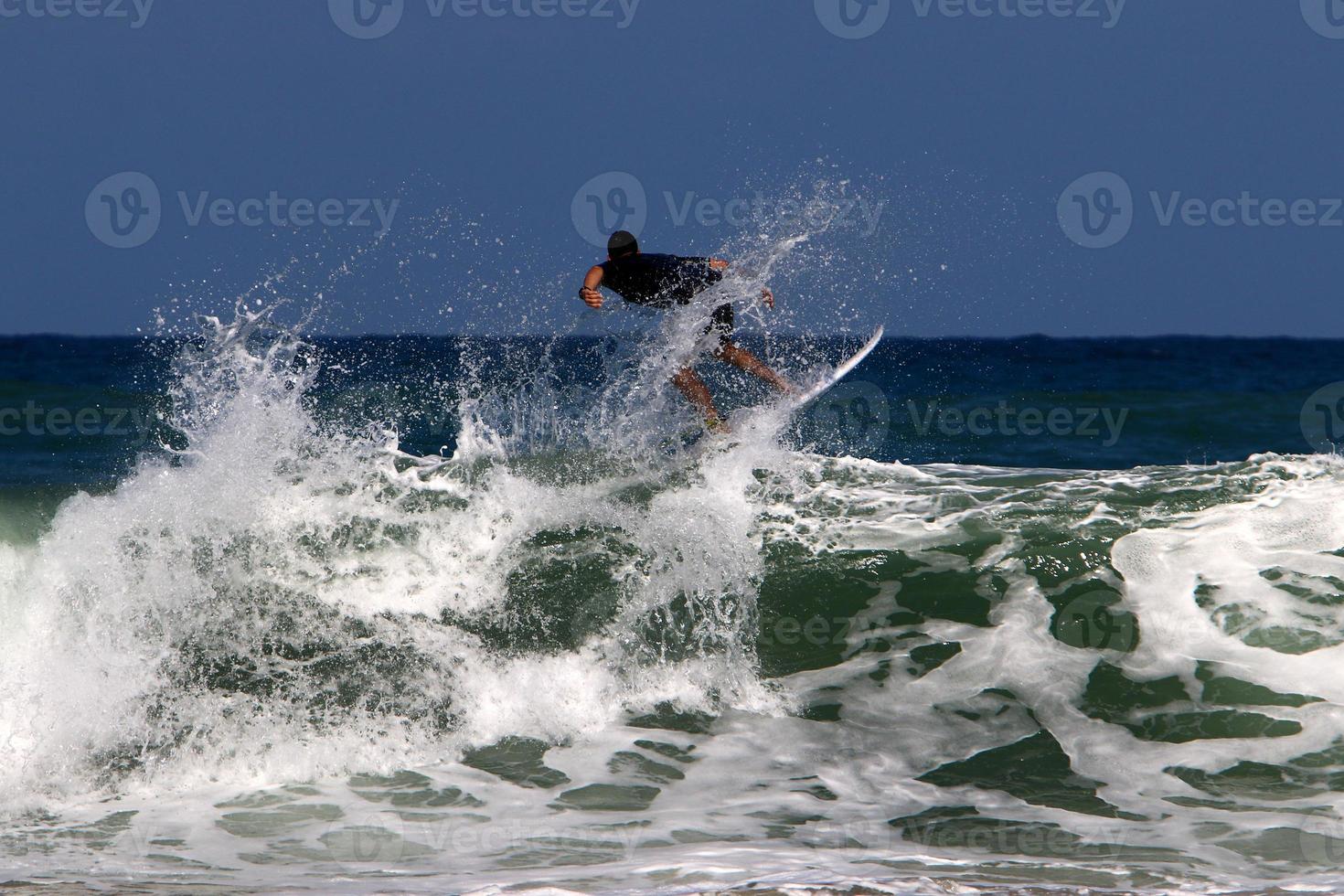 Surfing on high waves on the Mediterranean Sea in northern Israel. photo