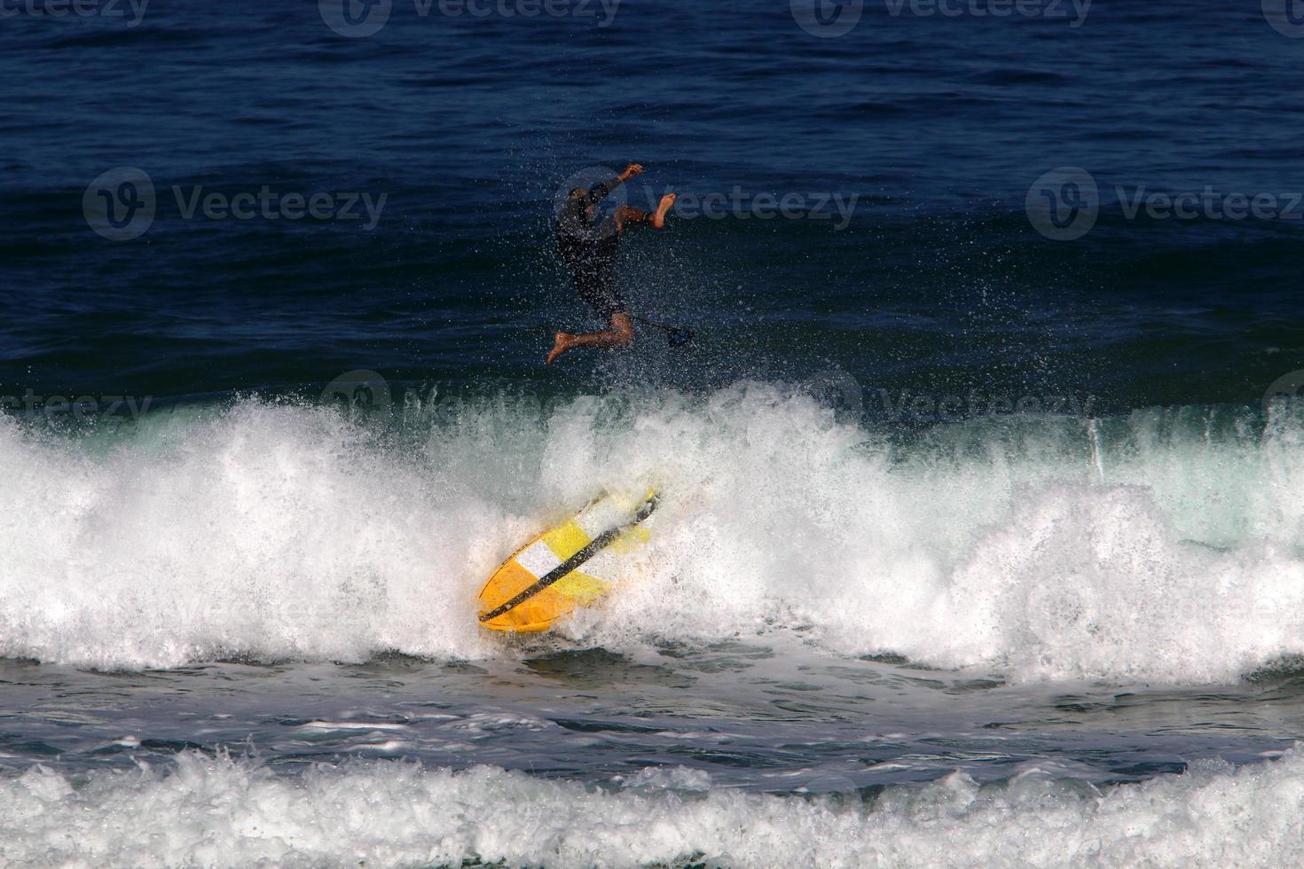 Surfing on high waves on the Mediterranean Sea in northern Israel. photo