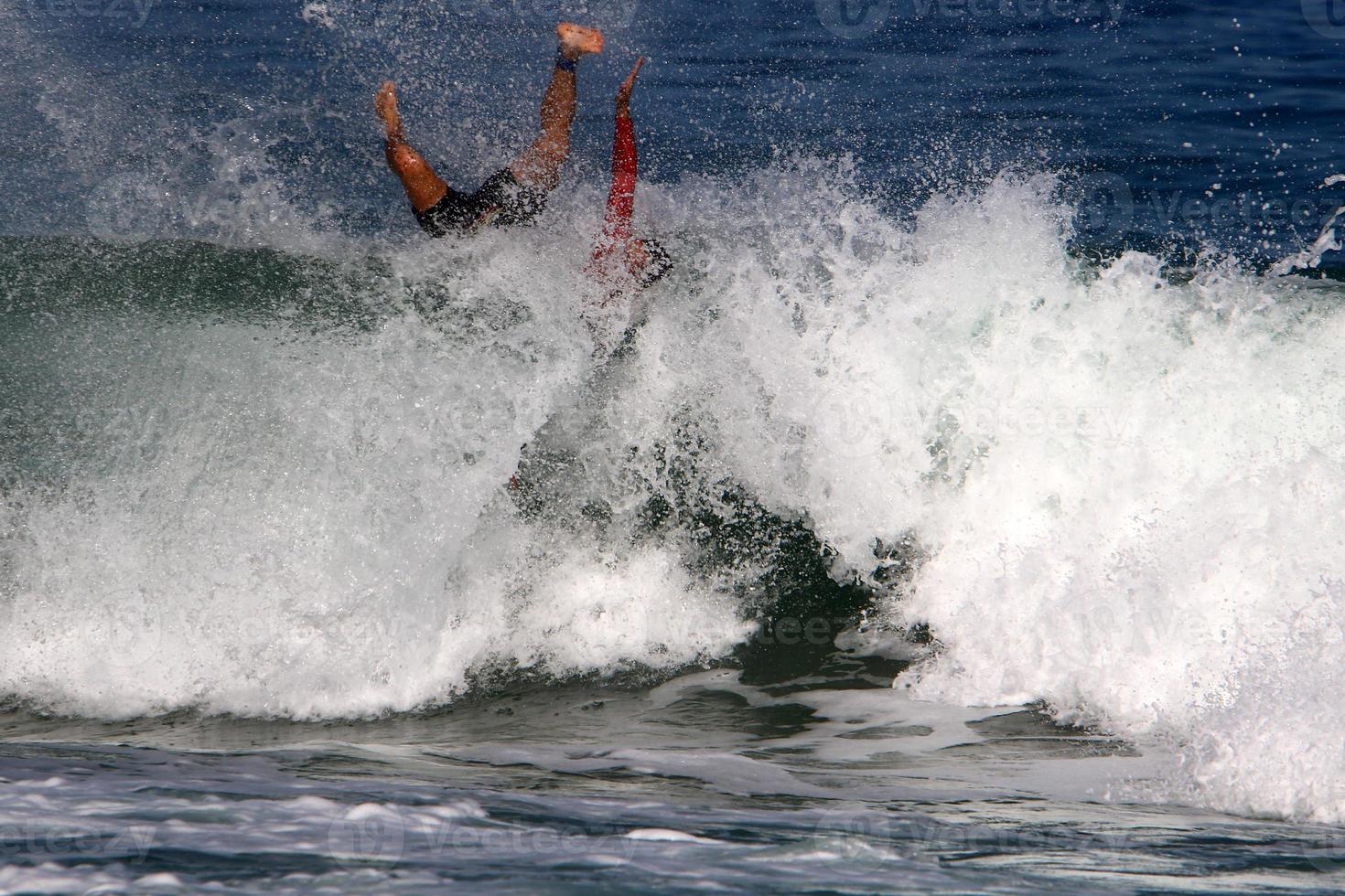 Surfing on high waves on the Mediterranean Sea in northern Israel. photo