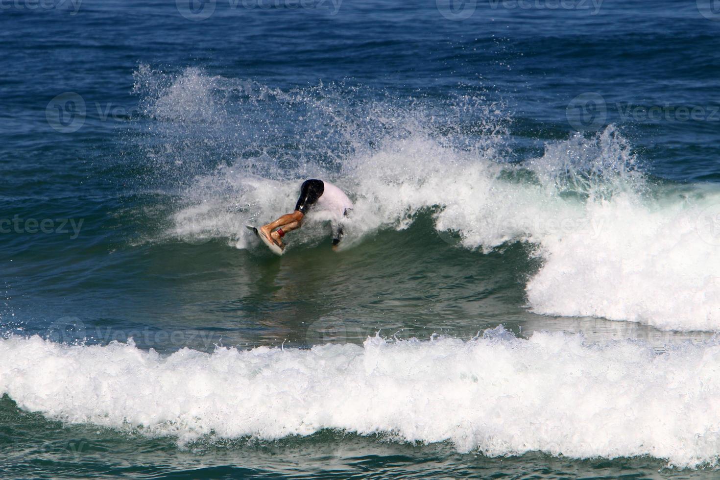 Surfing on high waves on the Mediterranean Sea in northern Israel. photo