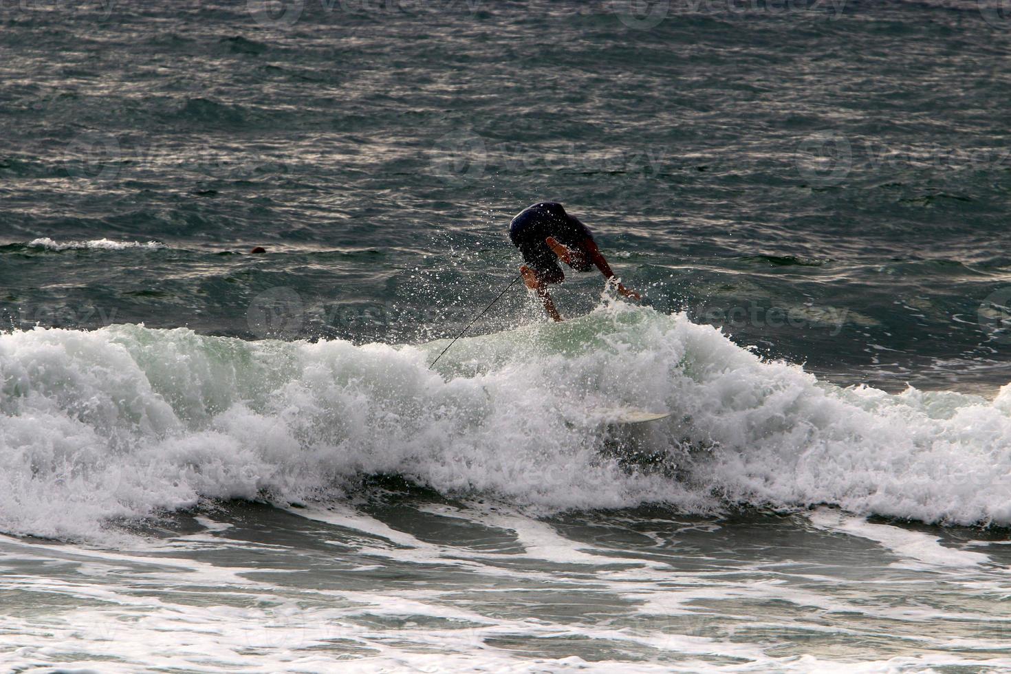 Surfing on high waves on the Mediterranean Sea in northern Israel. photo