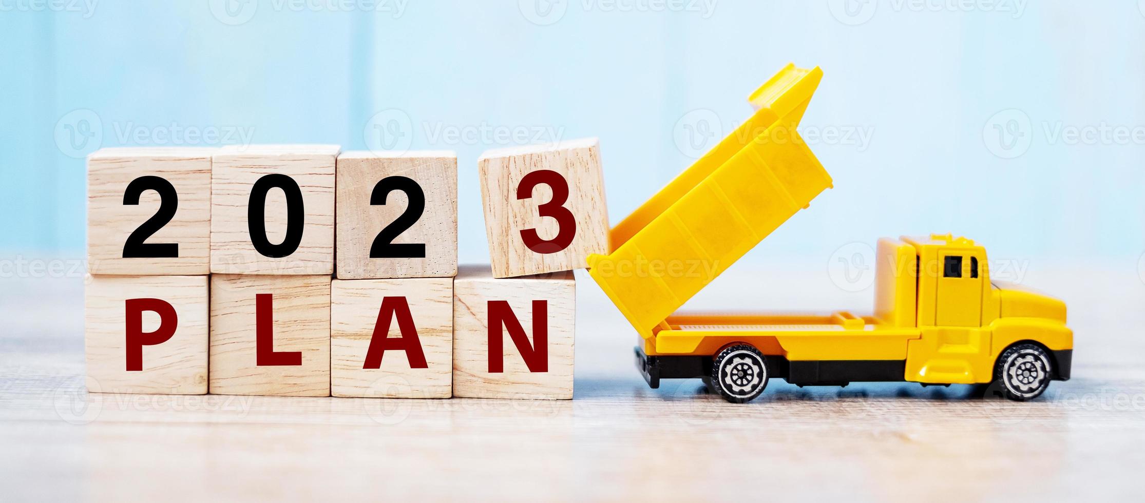 2023 Plan cube blocks with miniature truck or construction vehicle. New Start, Vision, Resolution, goal, industrial, Warehouse and happy New Year concept photo