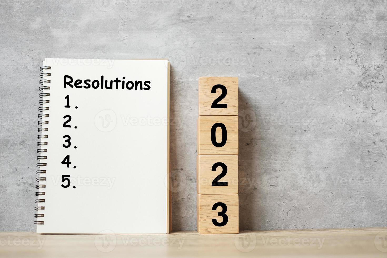 2023 Happy New Year with Resolution notebook and wooden number. countdown, Goals, Plan, Action and Mission Concept photo