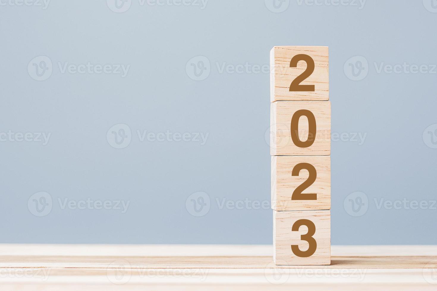wooden cube block with 2023 text on table background. Resolution, plan, review, goal, start and New Year holiday concepts photo