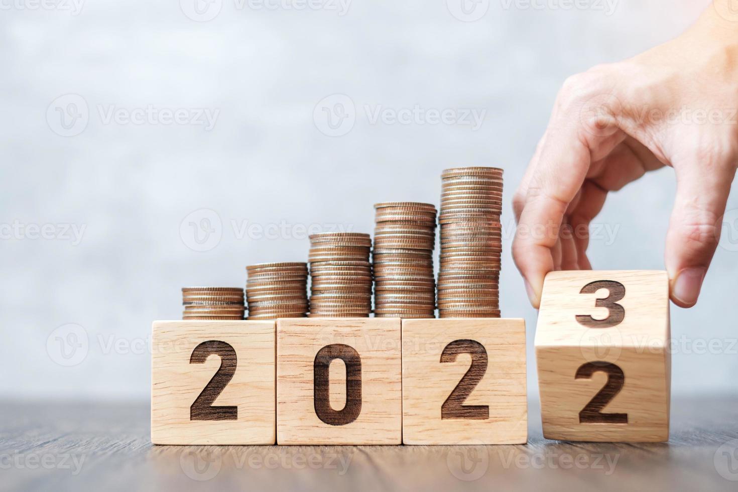 flipping 2022 to 2023 year block with Coins stack. Money, Budget, tax, investment, financial, savings and New Year Resolution concepts 12872267 Stock Photo at Vecteezy