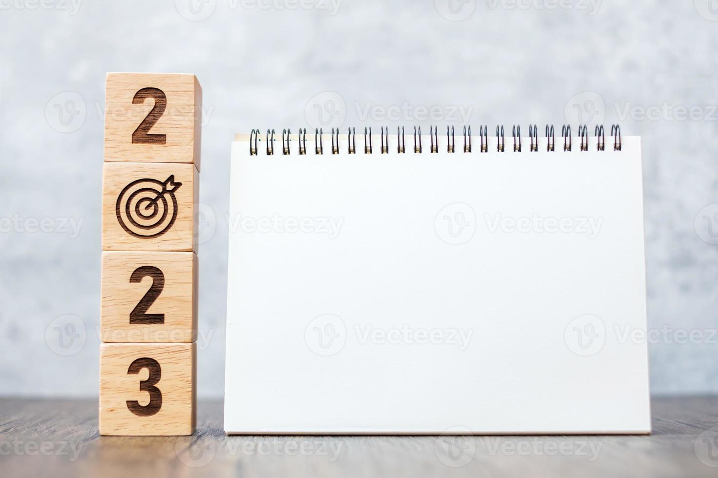 2023 Happy New Year with blank notebook and wooden number. countdown, Resolution, Goals, Plan, Action and Mission Concept photo