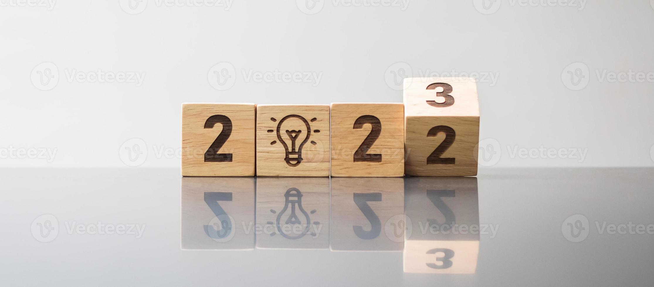 2022 to 2023 block with lightbulb icon. Business Idea, Creative, Thinking, brainstorm, Goal, Resolution, strategy, plan, Action, change and New Year start concepts photo