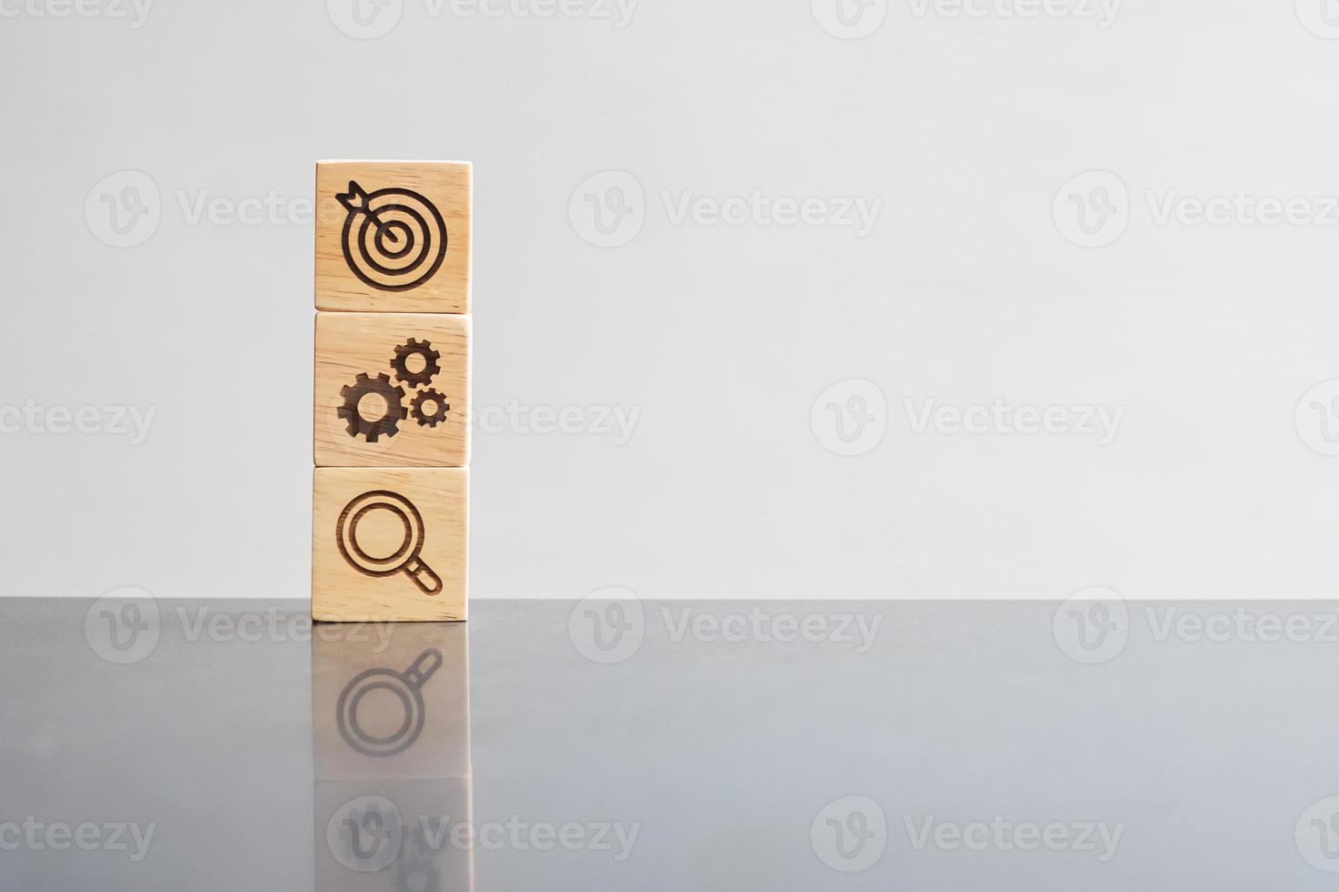 wood block with business goal, strategy, target, mission, action, objective, teamwork, brainstorm and idea concept photo