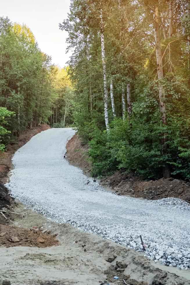Unfinished ski-roller track on the forest slopes. photo