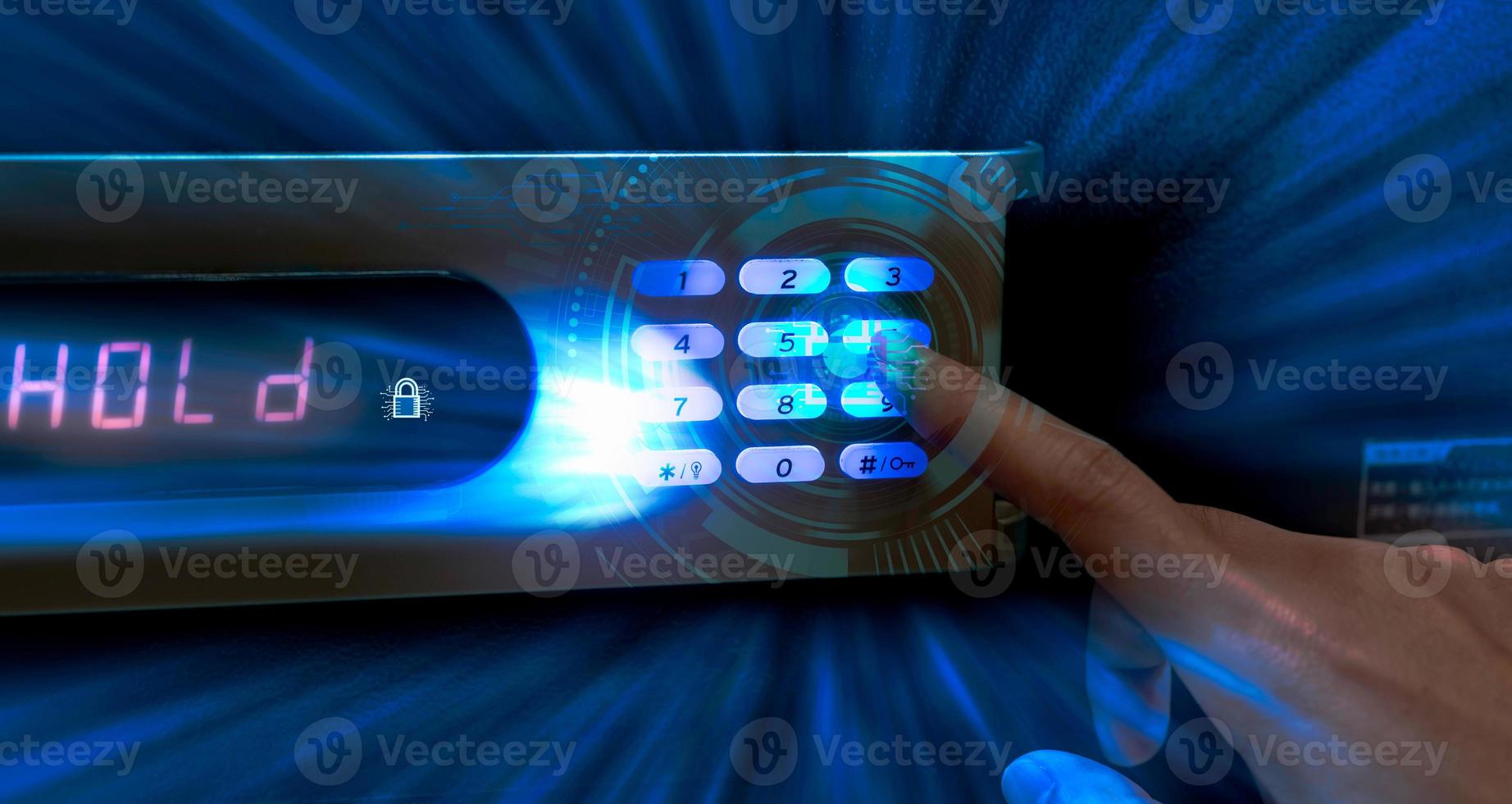Finger pressing password code on safe box to open metal safe in hotel. Cyber security and data protection concept. Business technology privacy and personal information policy concept. Wealth protect. photo
