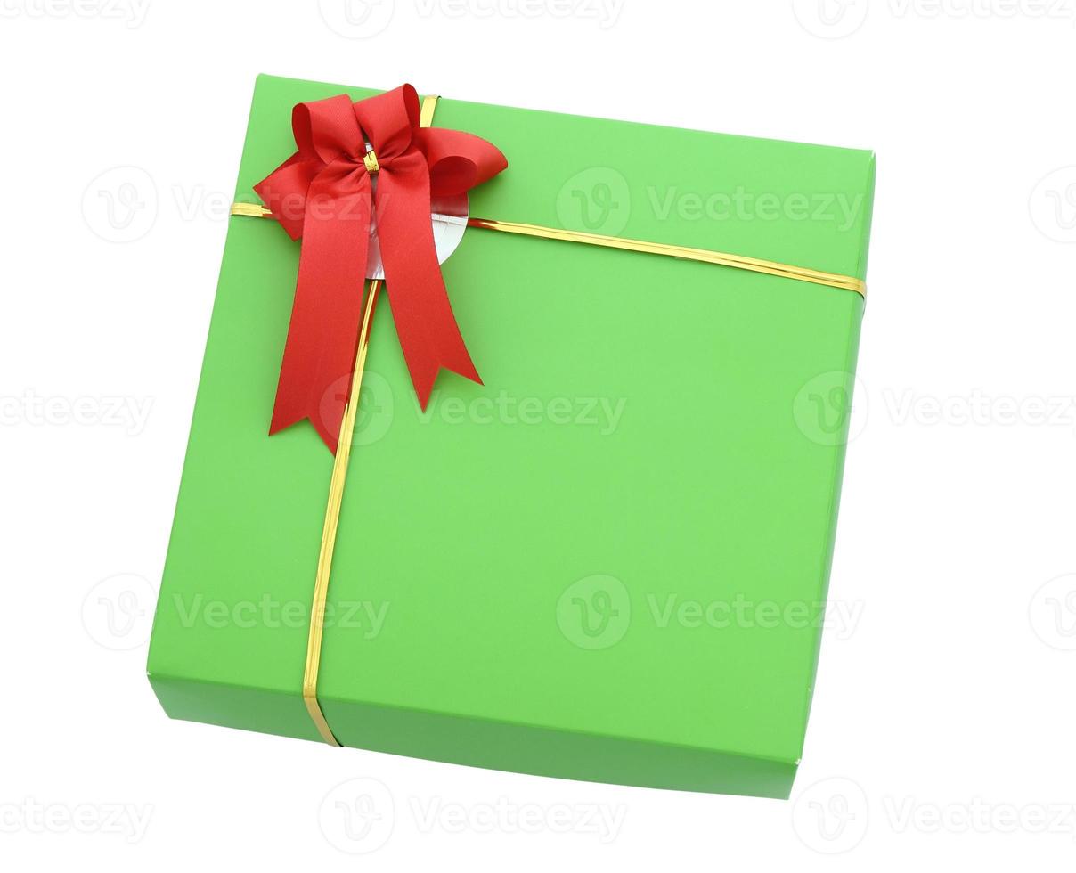 Green gift box with red ribbon bow isolated on white with clipping path photo