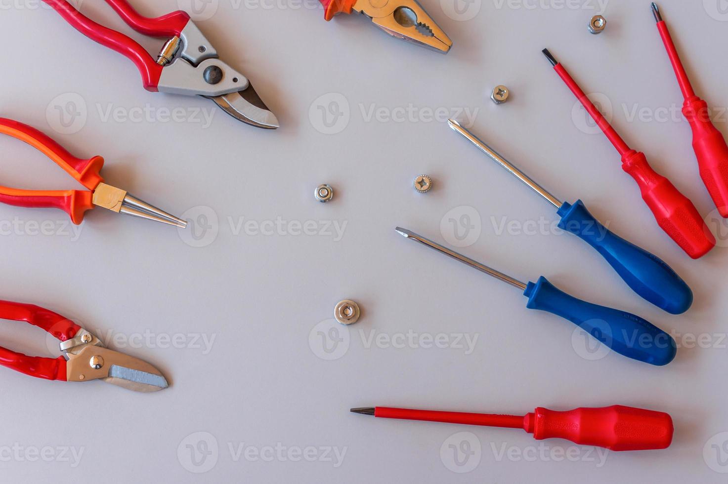 Flat lay of set of tools for car repairing and home maintenance on grey background. Top view. photo