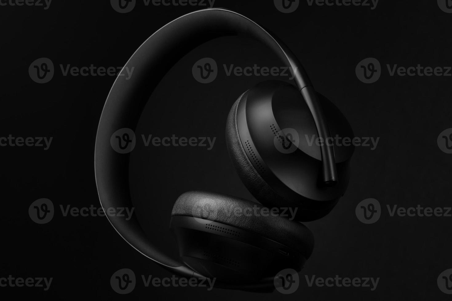 auriculares negros de primera calidad sobre fondo negro foto