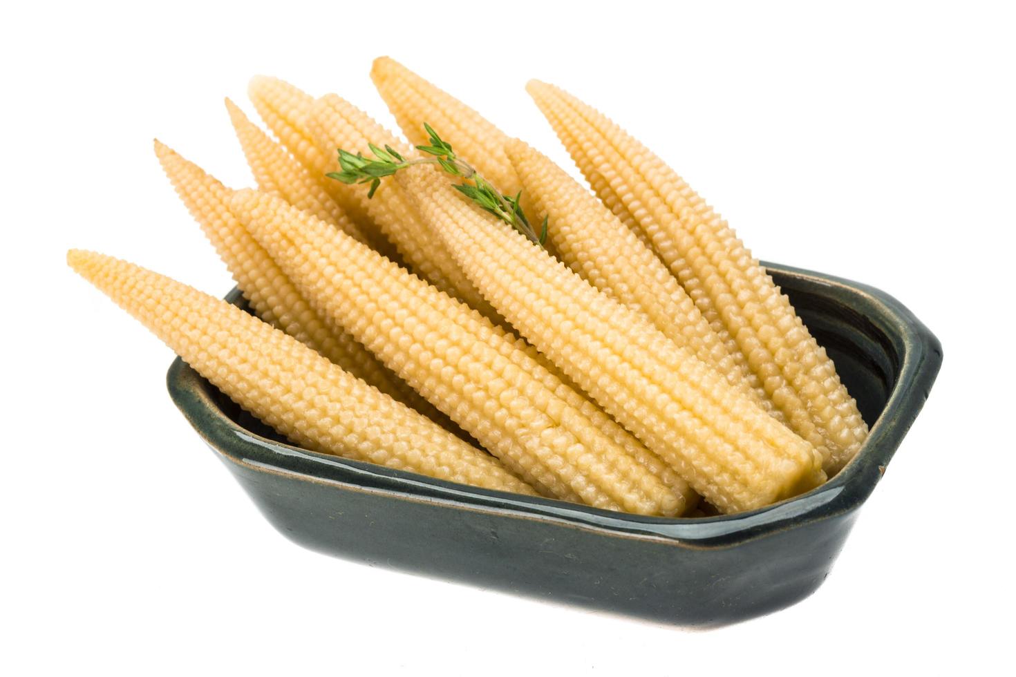 Baby corn in a bowl on white background photo