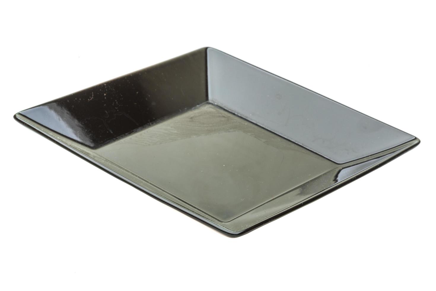Black plate on white background photo