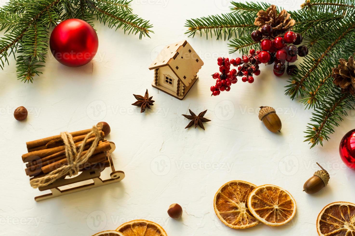 Christmas backdrop with traditional New Year's organic ingredients-slices of dried orange, cinnamon, anise stars and wooden toys. photo