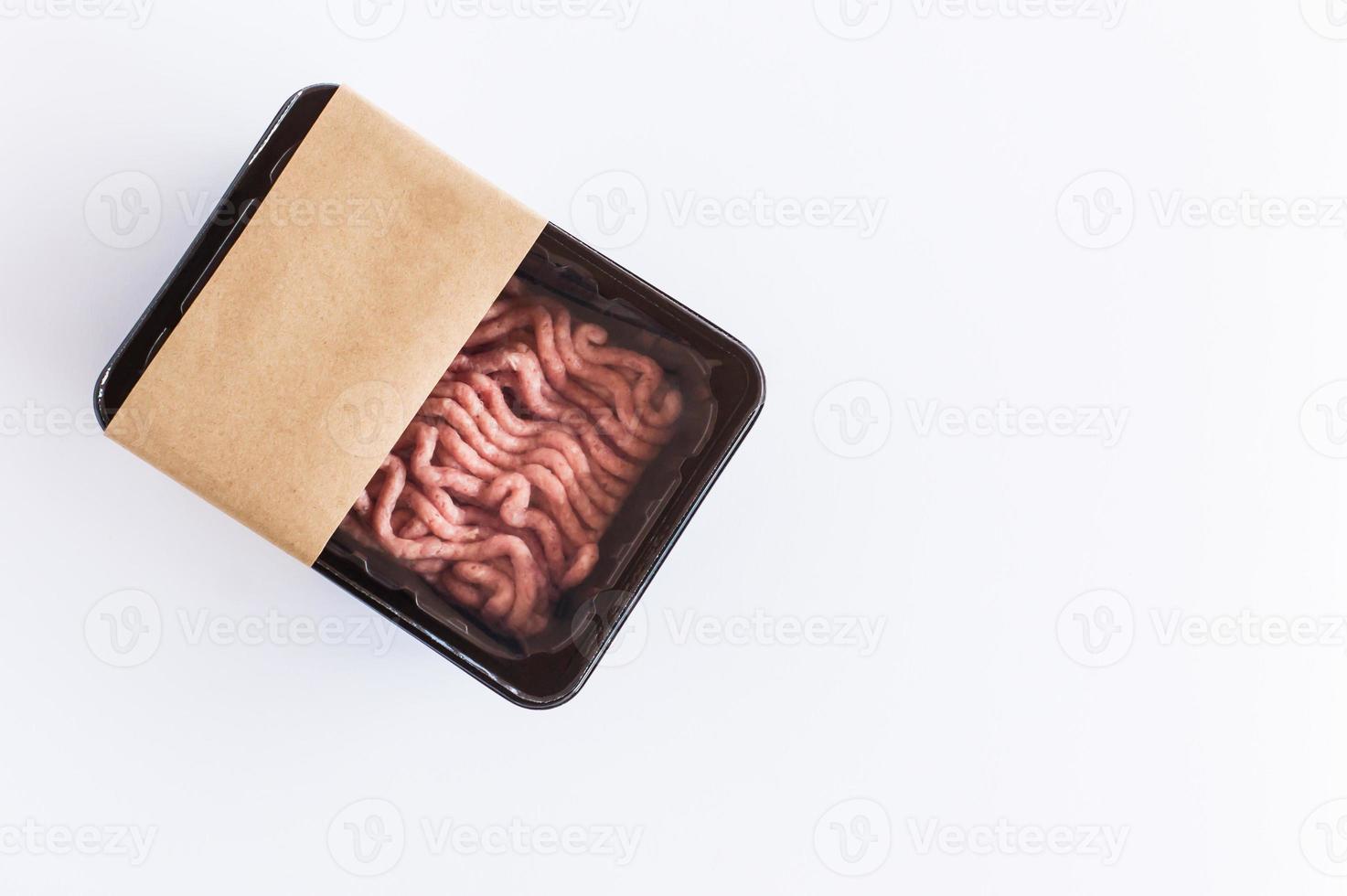 fresh raw minced meat in plastic vacuum packaging on a white background. top view. logo layout design. photo