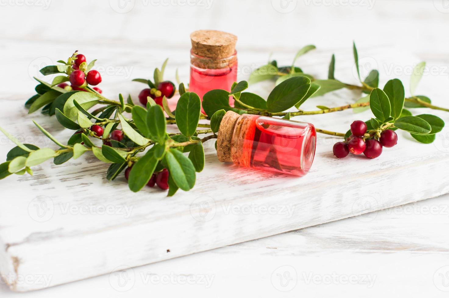moisturizing oil-fluid for the face with extract of viburnum berries. vitamin E. white wooden pedium. photo