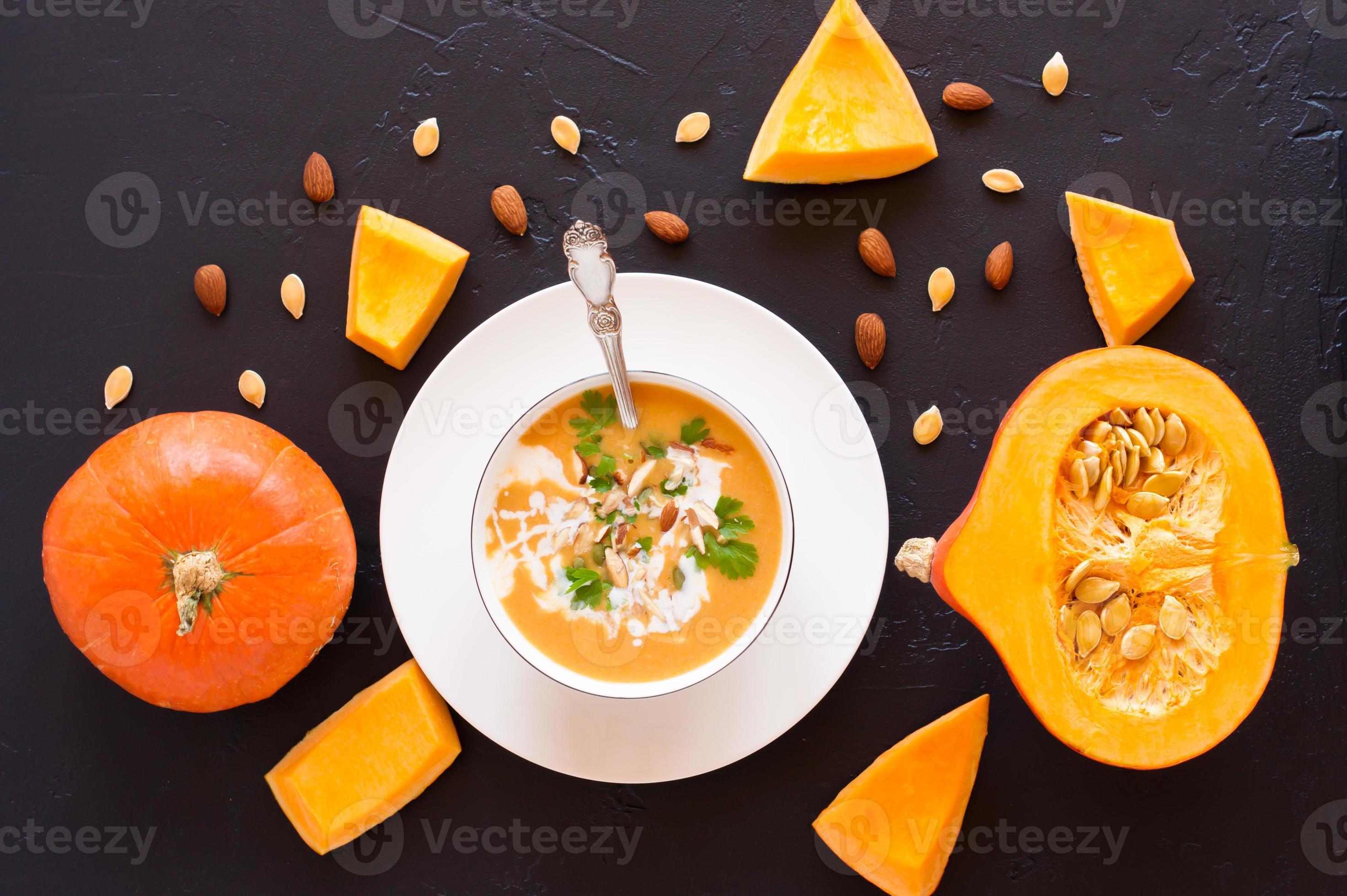 A Plate Of Pumpkin Soup Ripe Pumpkin With Seeds And Almonds On A Black easy-slow-cooker-pumpkin-soup-where-is-my-spoon