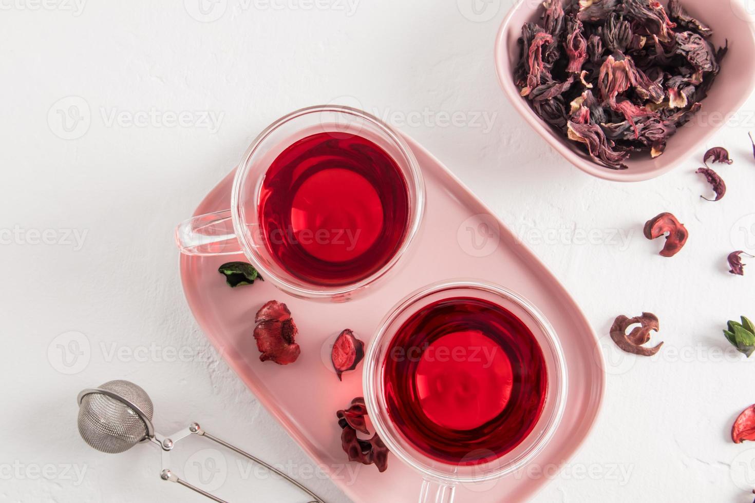 top view of glass transparent cups with hibiscus tea made of dry rose petals. delicious healthy drink, vitamin tea for colds and flu. photo