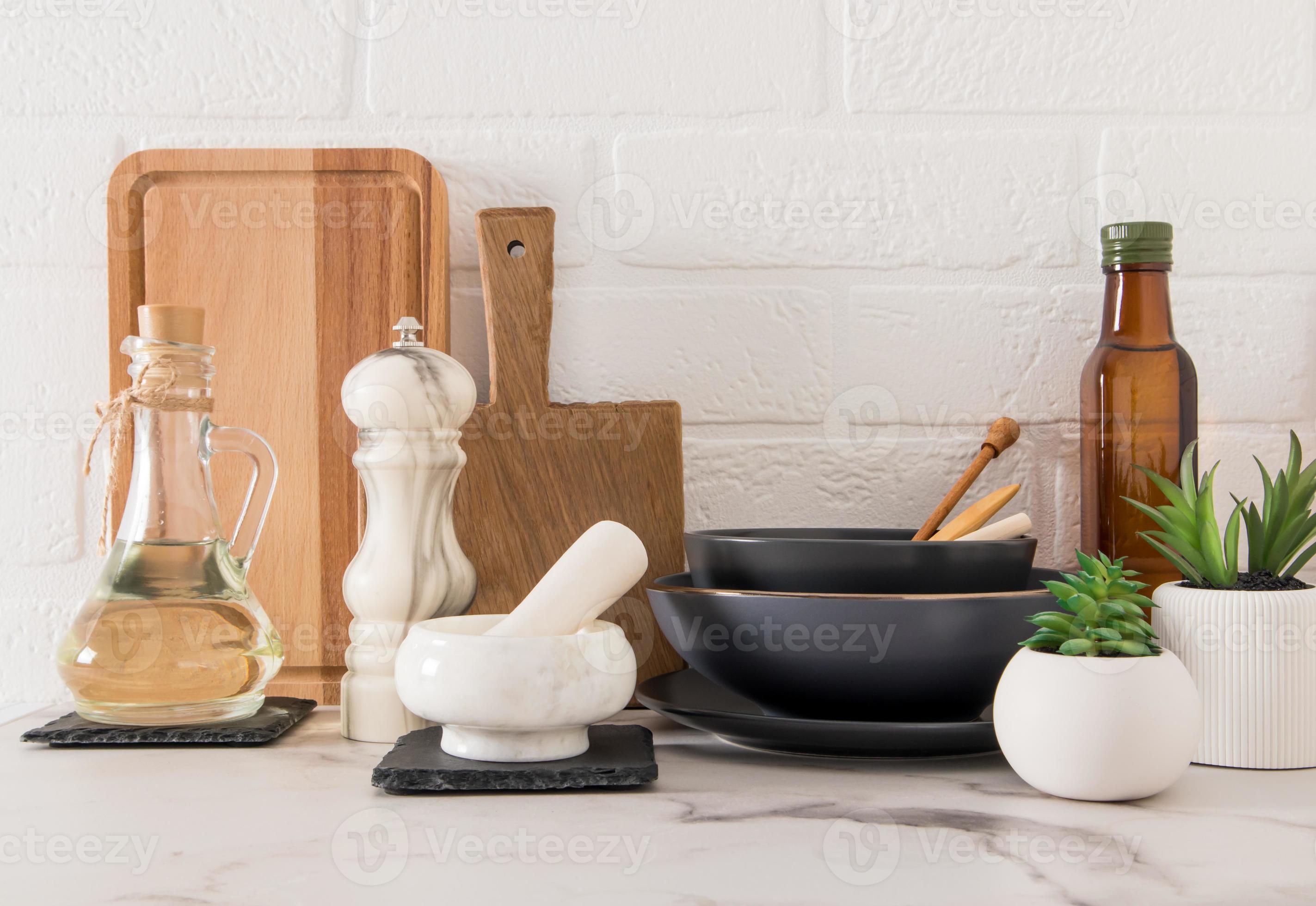 https://static.vecteezy.com/system/resources/previews/012/875/435/large_2x/a-set-of-various-modern-kitchen-utensils-on-a-marble-countertop-against-a-white-brick-wall-eco-friendly-materials-without-plastic-photo.jpg