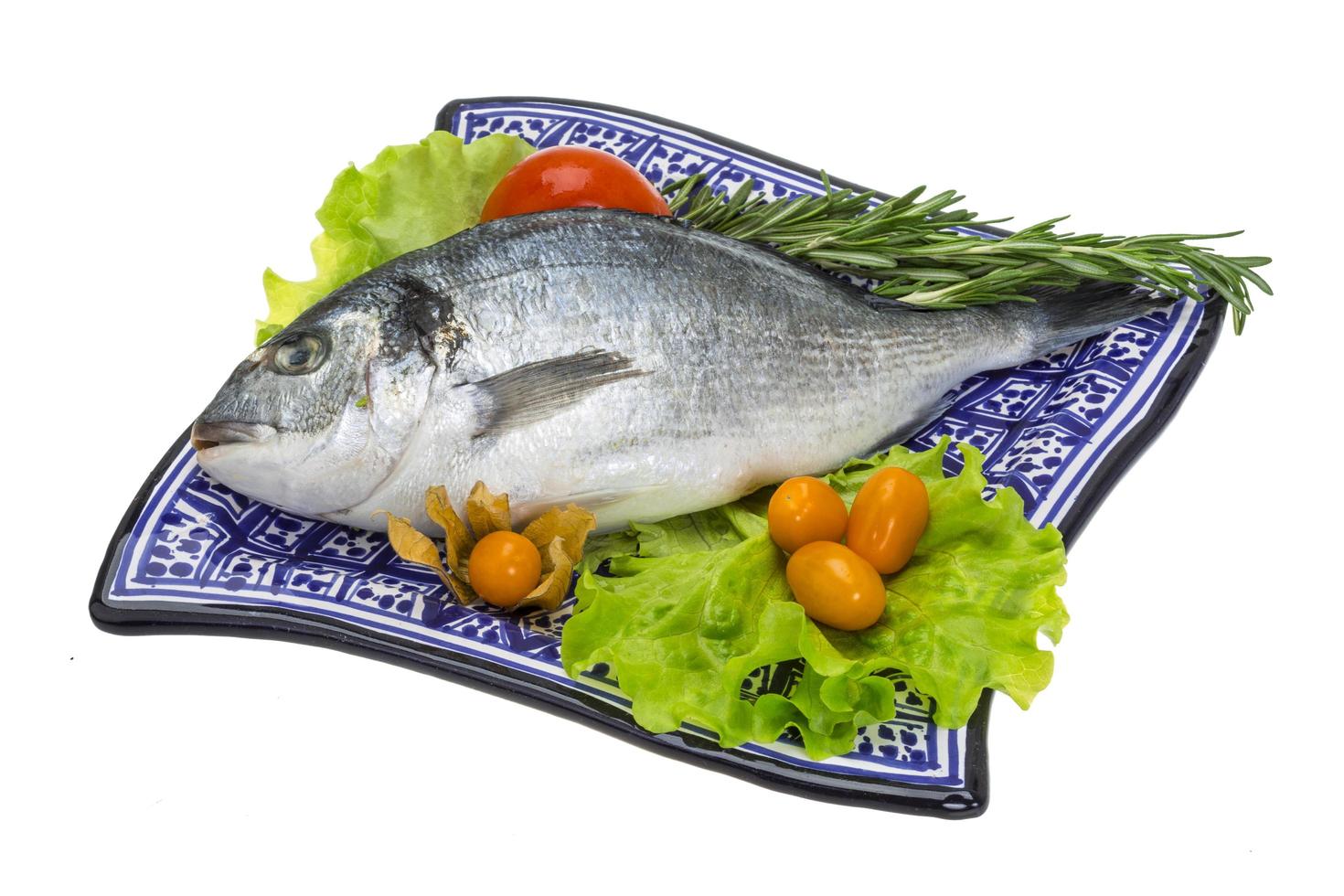 Raw dorado on the plate and white background photo