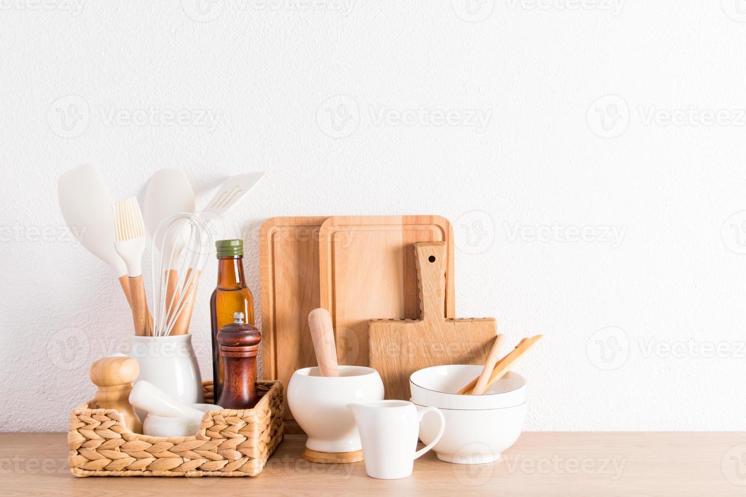 environmentally friendly items of modern utensils on a kitchen wooden countertop near a white textured wall. eco-friendly materials without plastic. photo