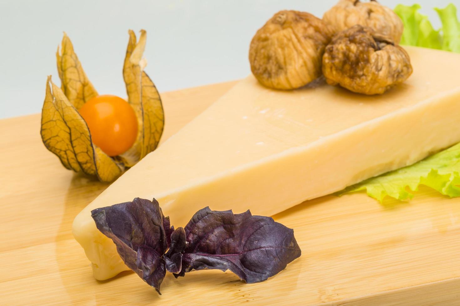 Parmesan cheese on wooden board and white background photo