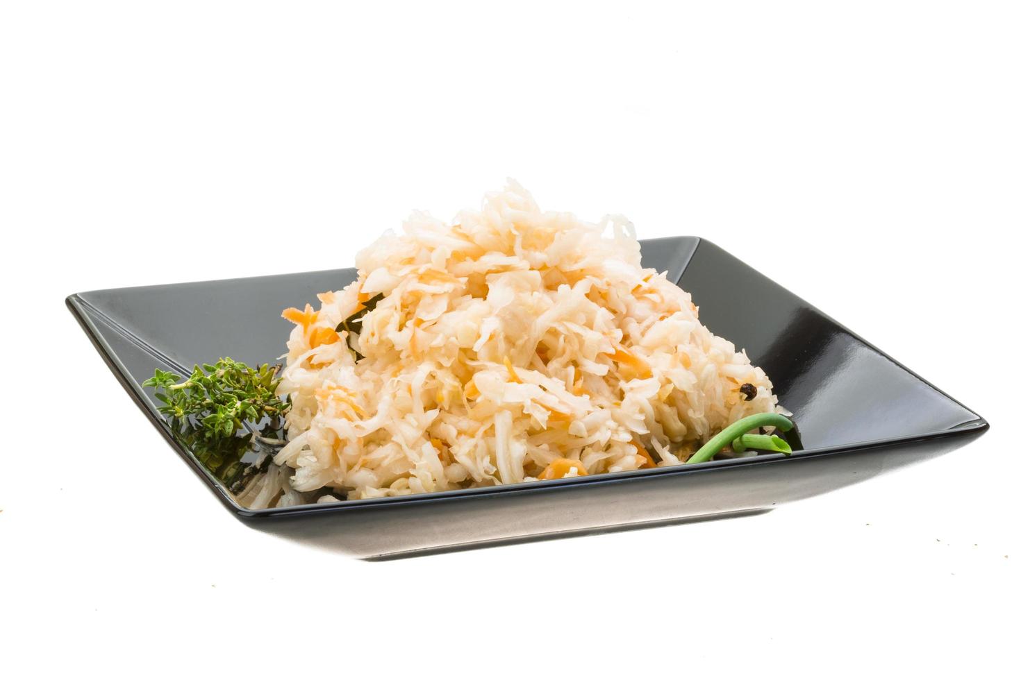 Fermented cabbage on the plate and white background photo