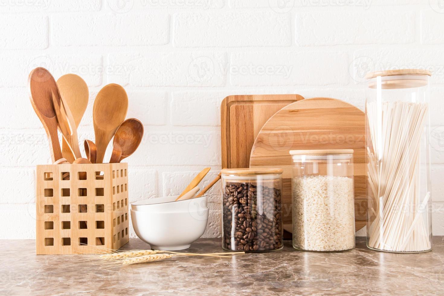 https://static.vecteezy.com/system/resources/previews/012/876/002/non_2x/a-set-of-kitchen-utensils-on-a-dark-marble-countertop-against-a-white-brick-wall-interior-background-of-the-kitchen-photo.jpg