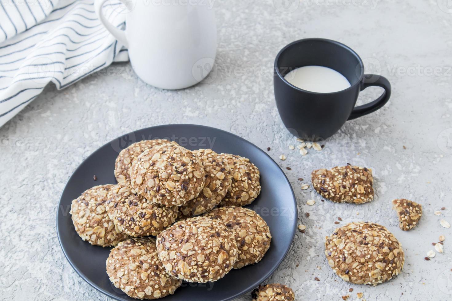 delicious healthy breakfast. oatmeal homemade cookies on a plate with a cup of fresh milk. photo