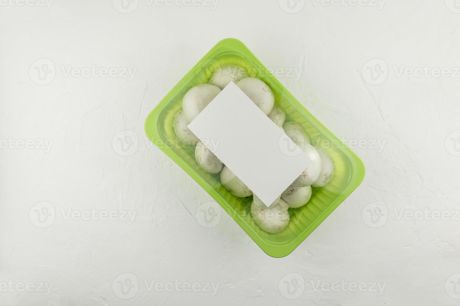 sealed packaging of champignons on a white background. top view. logo layout design. the concept of industrial mushroom cultivation and packaging. photo