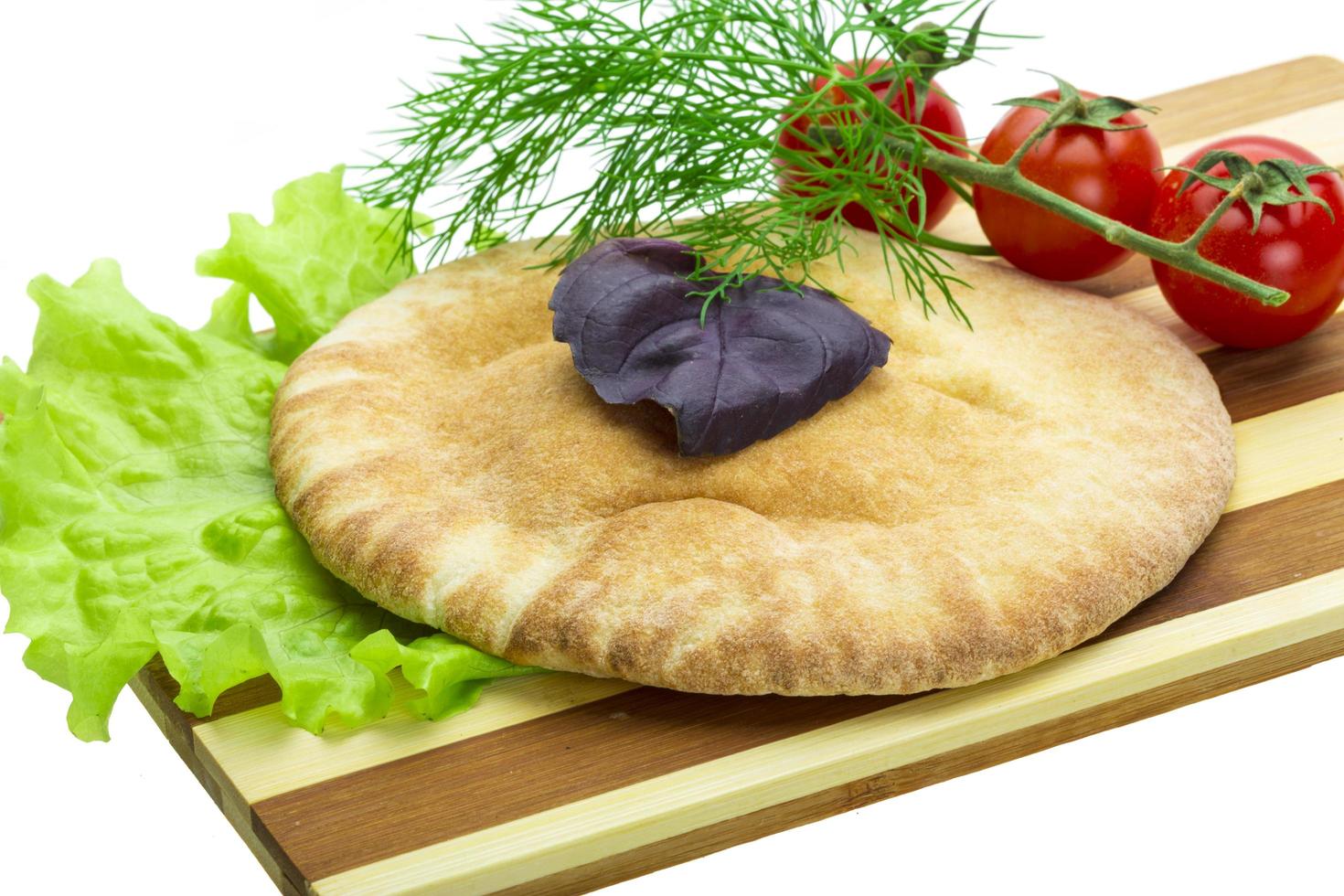 Armenian bread on wooden board and white background photo