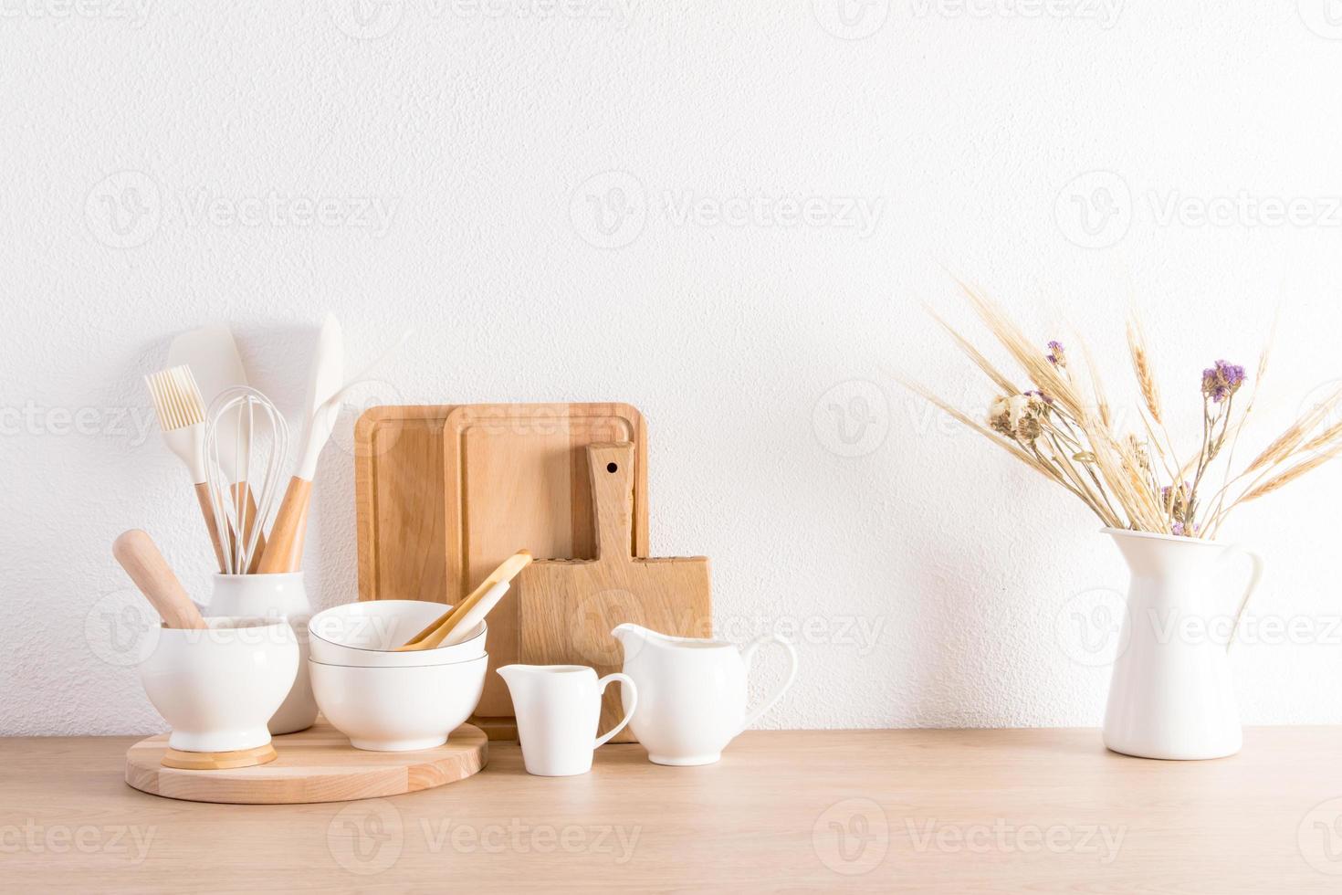 Stylish white kitchen background with utensils and dried flower in a jug. interior in light colors. ecologically clean kitchen. photo