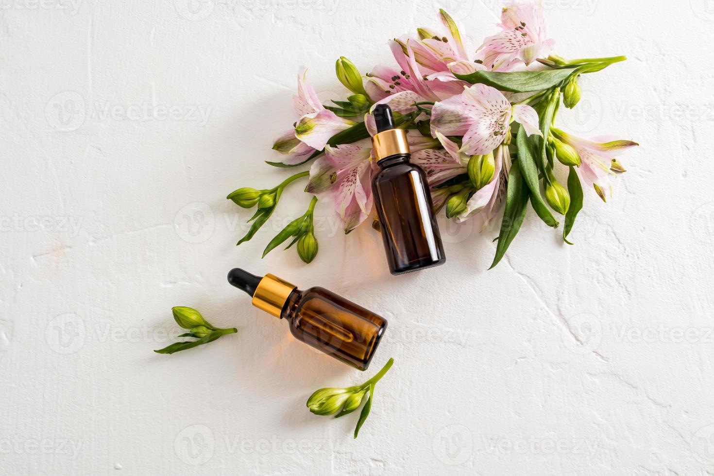 top view of two cosmetic bottles with a pipette with a natural organic product. the concept of spring cosmetics and beauty. photo