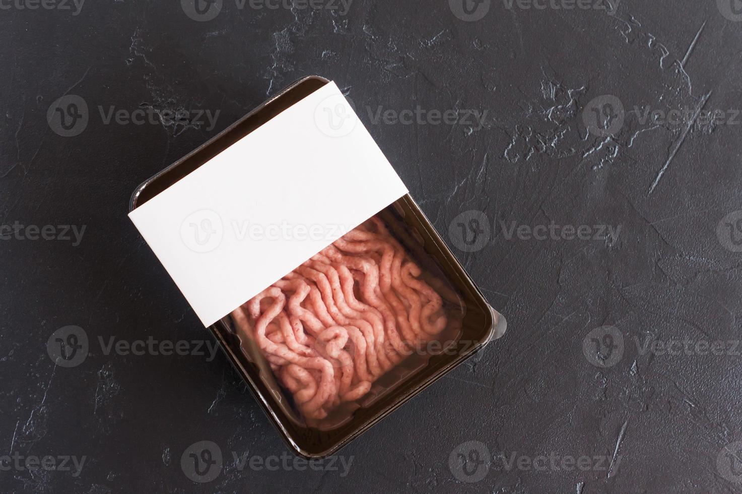 fresh minced poultry meat in vacuum packaging. half-finished product. top view. logo mockup for design. photo
