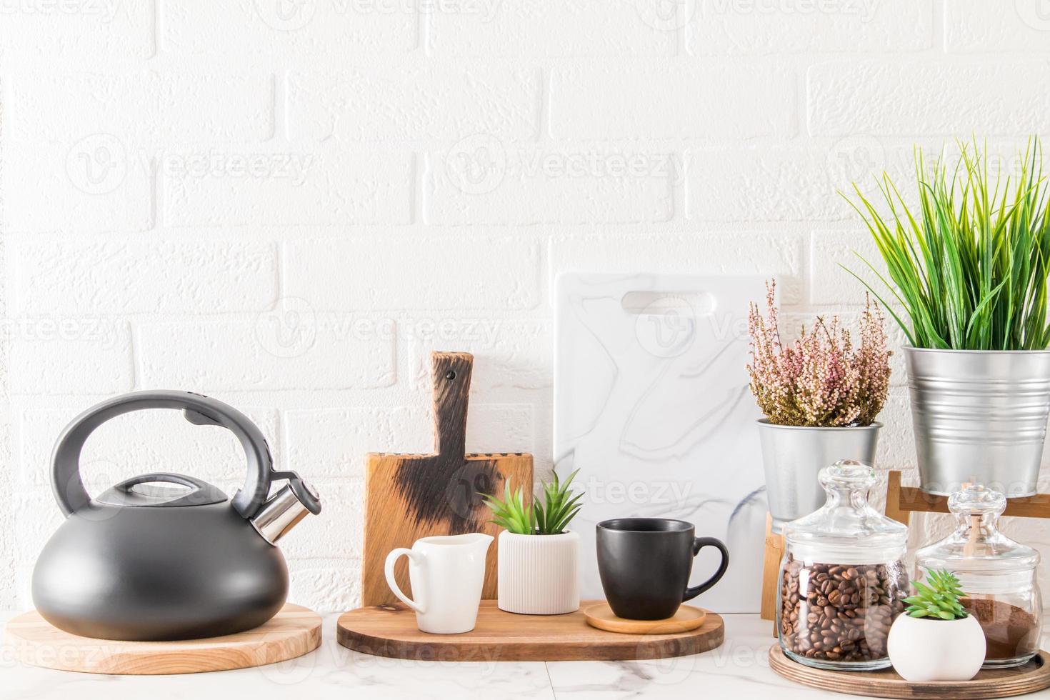 Elegante fondo de cocina blanco con utensilios de cocina y plantas de interior verdes en hermosas macetas. vista frontal. el concepto de casas limpias. foto