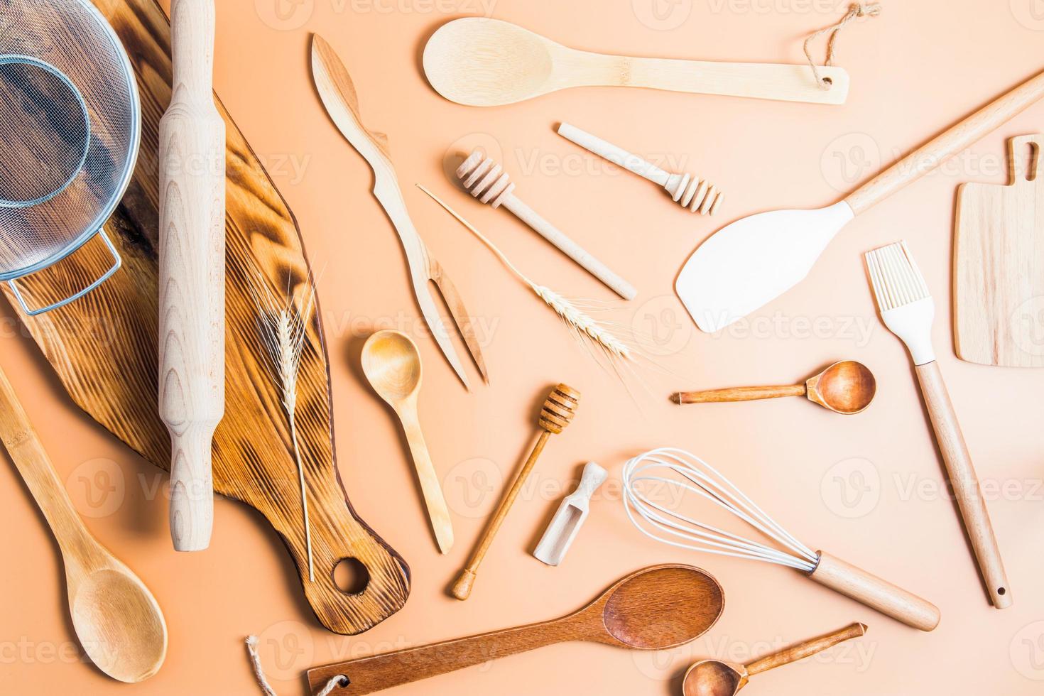 a collection of various kitchen utensils for cooking on a brown background. top view. flat styling. environmentally friendly items. photo