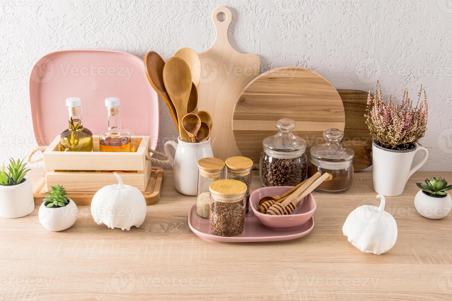 interior background of the kitchen. modern countertop with various kitchen utensils, cans and containers for food storage. white pumpkin decor. photo