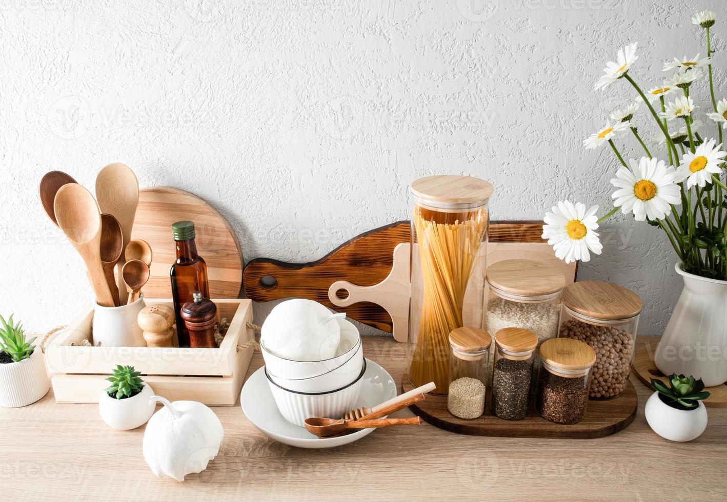 fashionable food storage area in the kitchen on a modern countertop. cutting boards, cans, containers. eco-friendly materials. without plastic. photo
