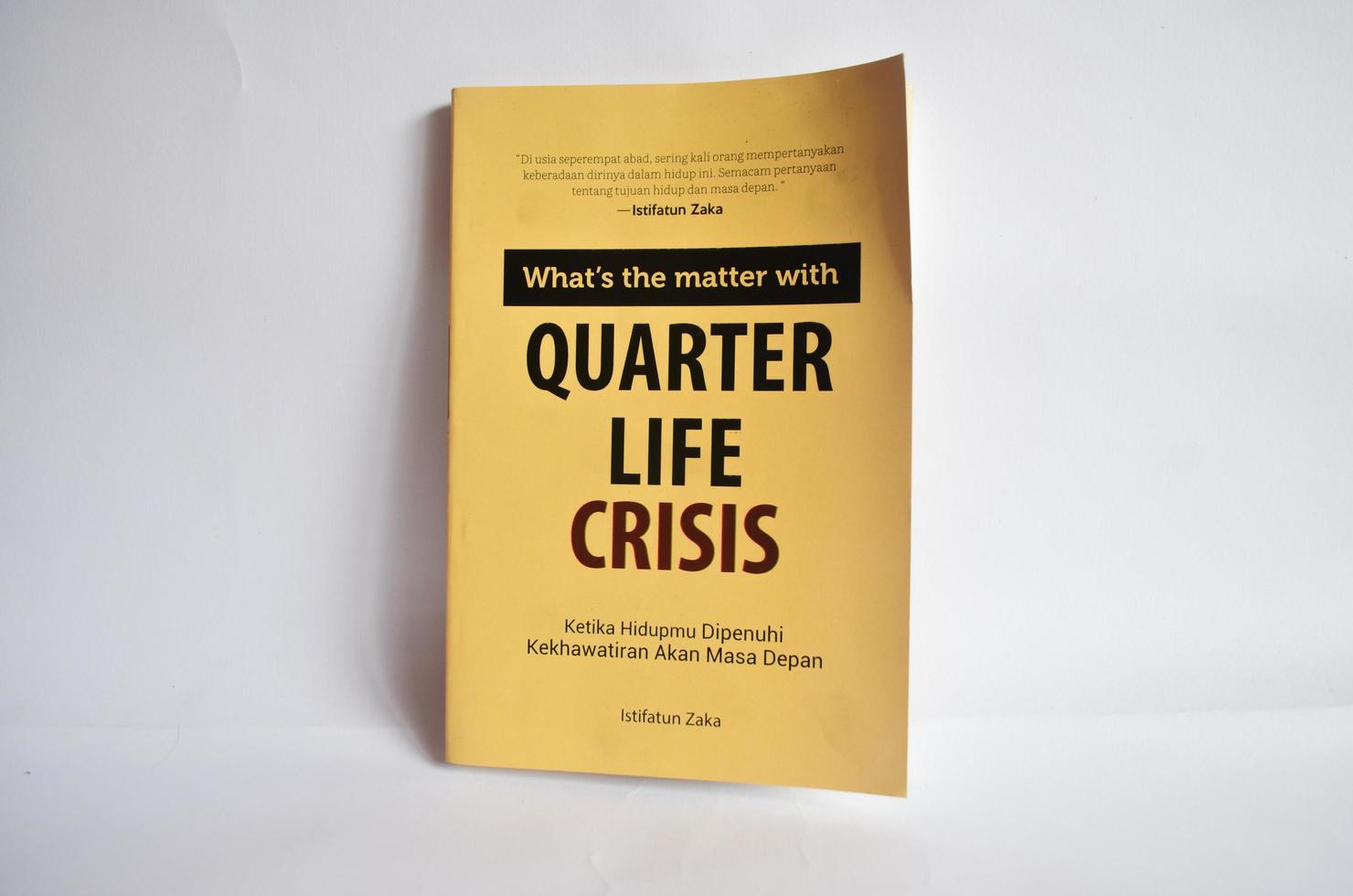 Blitar, Indonesia - October 9th 2022 A book with the title Quarter Life Crisis by Istifatun Zaka which contains worries about life. Elegant yellow cover book and isolated on white background photo