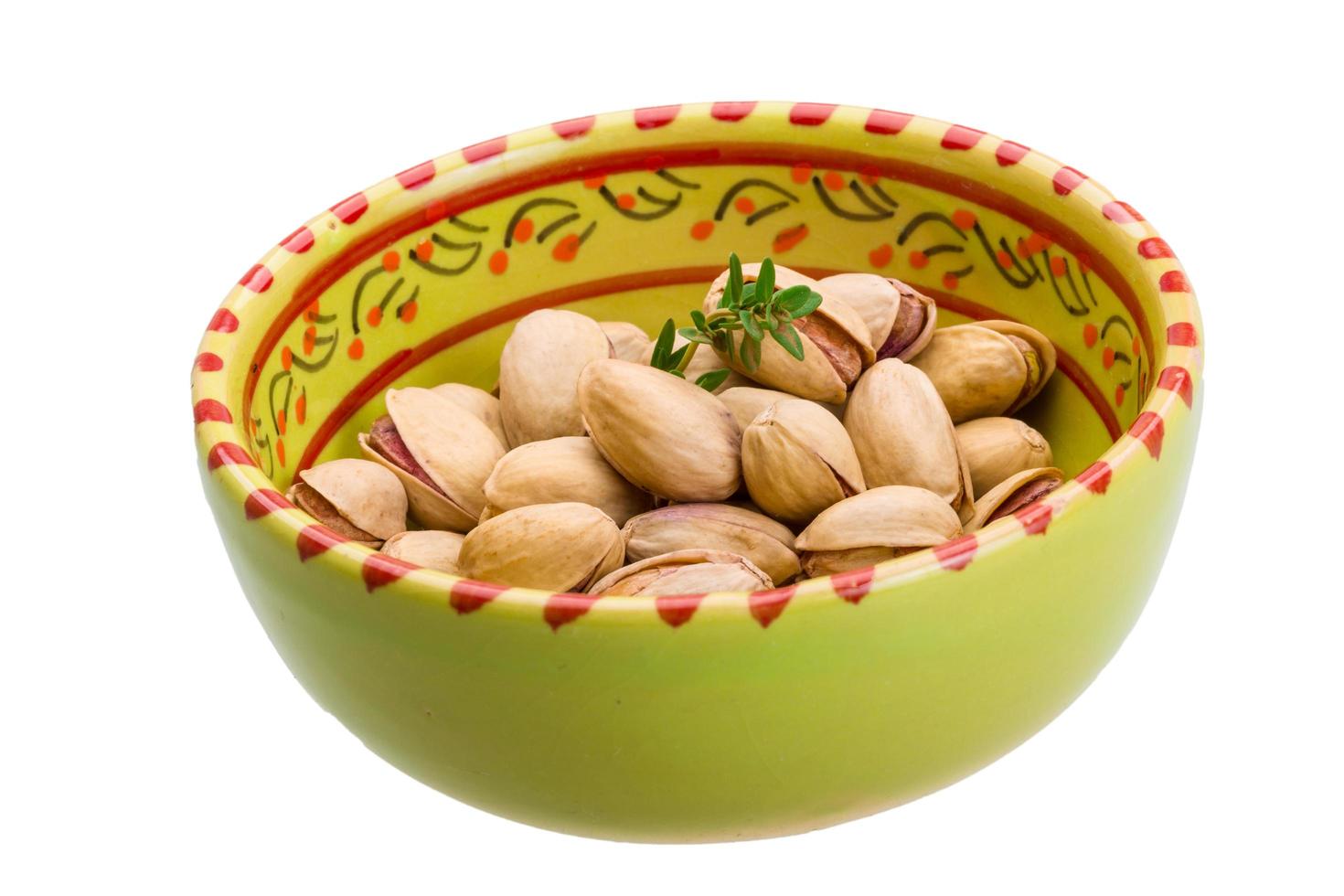 Pistachio in a bowl on white background photo