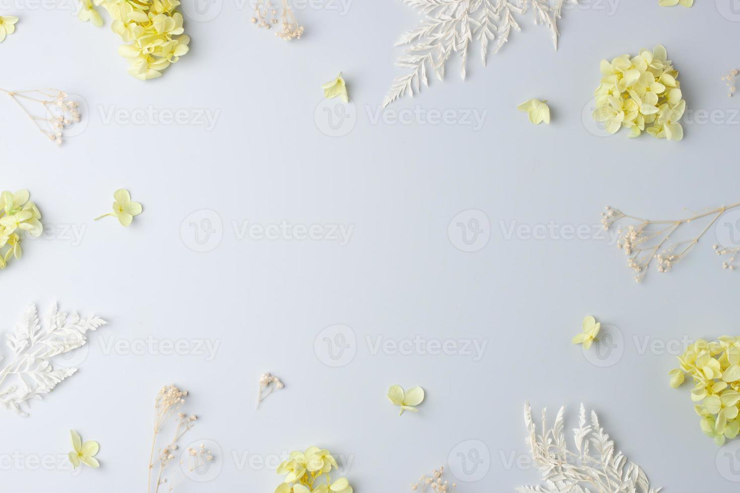 Cosmetic background with flowers on grey. Flat lay, copy space photo