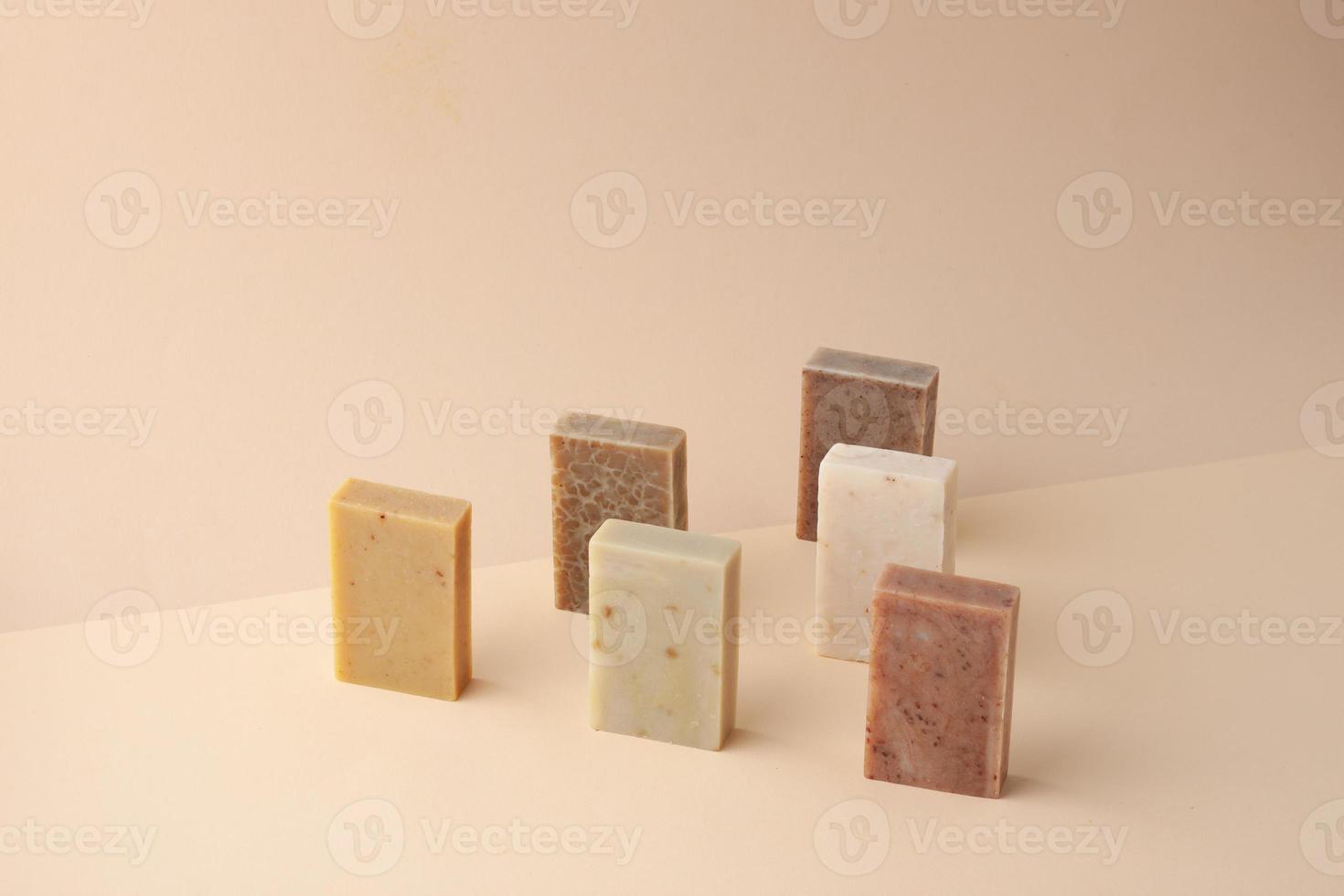 Composition with soap on pastel beige background. Close up, copy space. photo