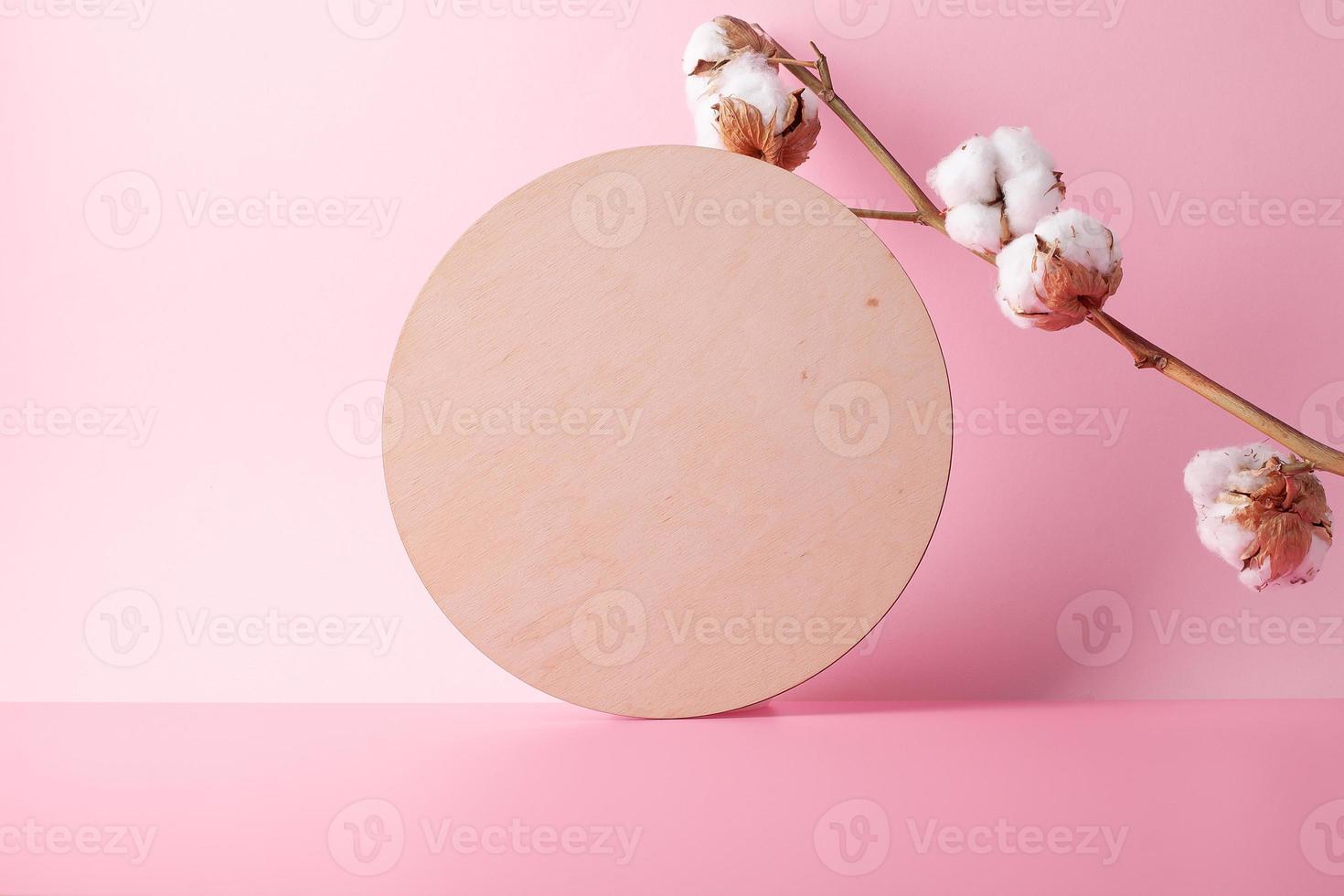 Cosmetic background with wooden and pampas on pink. Empty showcase for cosmetic product presentation. Copy space photo